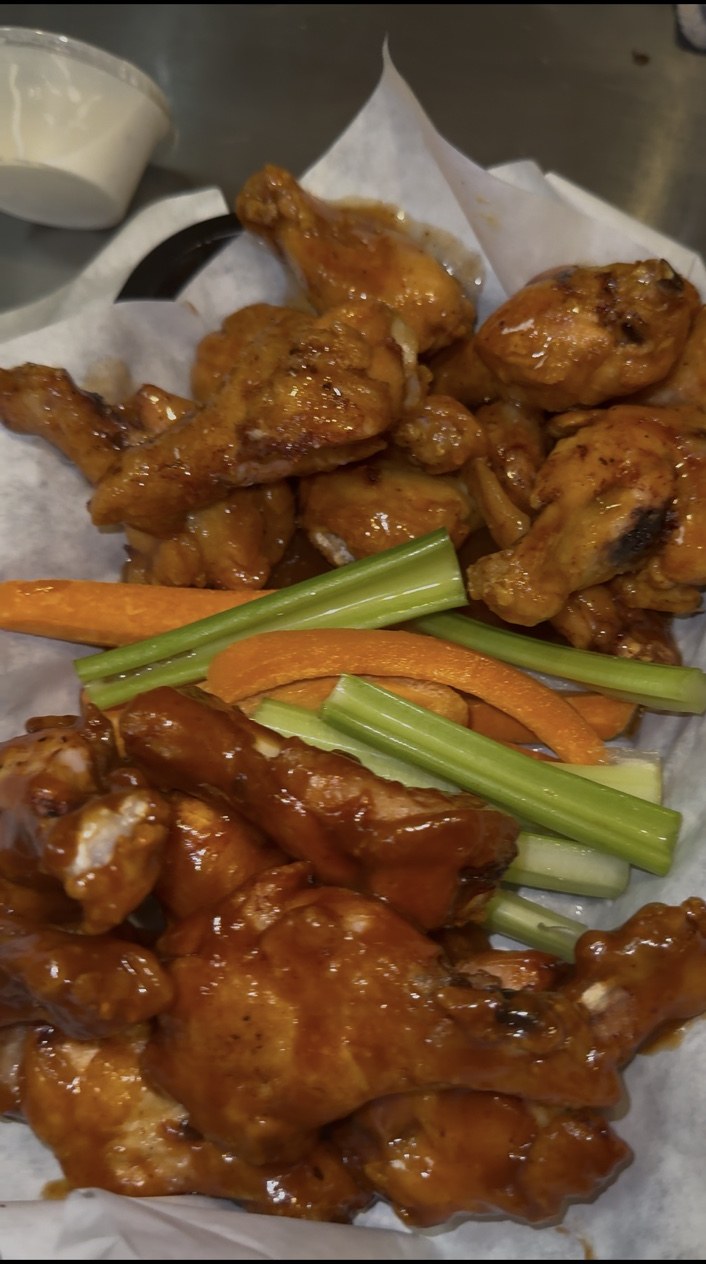 Sauced bone-in wings with celery and carrots at Famous Sam’s River Road in Tucson